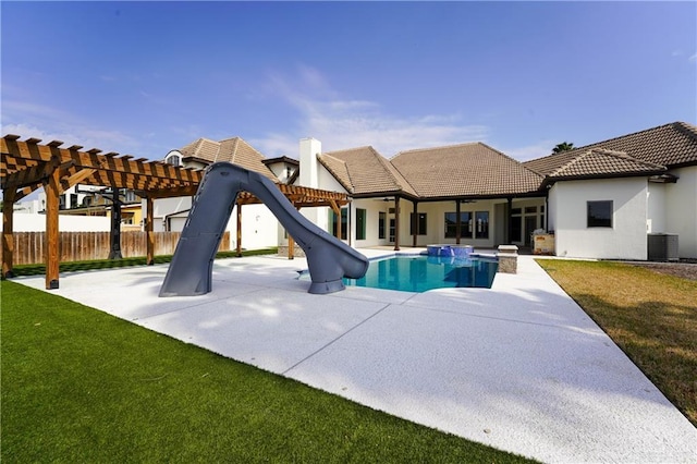 view of swimming pool featuring a water slide, a yard, a patio area, and a pergola