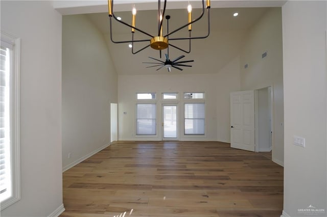 interior space featuring ceiling fan, light wood-type flooring, and high vaulted ceiling