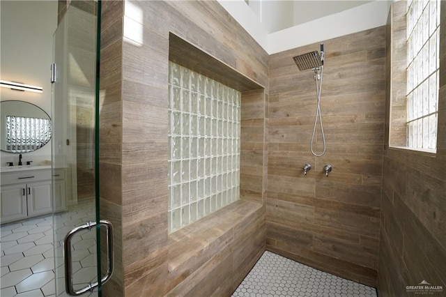 bathroom with vanity and a shower with shower door