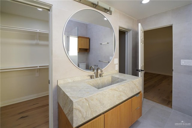 bathroom with hardwood / wood-style flooring, vanity, and toilet