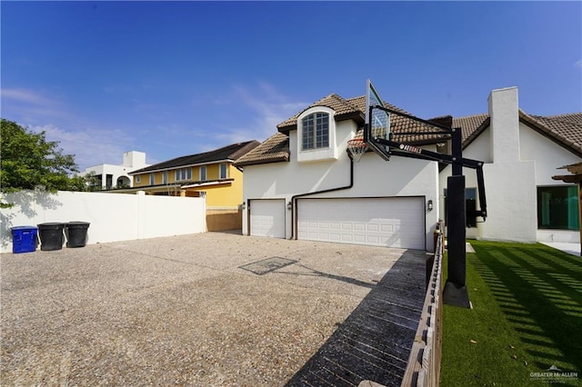 view of home's exterior with a yard and a garage