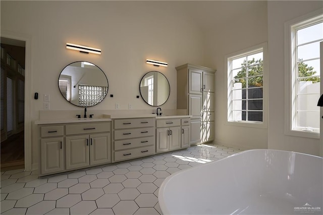 bathroom featuring vanity and a washtub