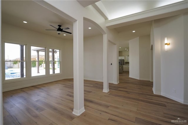 spare room featuring wood-type flooring and ceiling fan