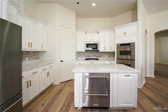 kitchen with white cabinetry, a center island, and appliances with stainless steel finishes