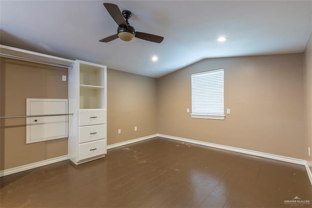 unfurnished bedroom featuring dark hardwood / wood-style floors, ceiling fan, and lofted ceiling