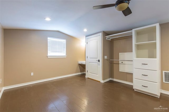 unfurnished bedroom featuring dark hardwood / wood-style flooring, ceiling fan, and lofted ceiling