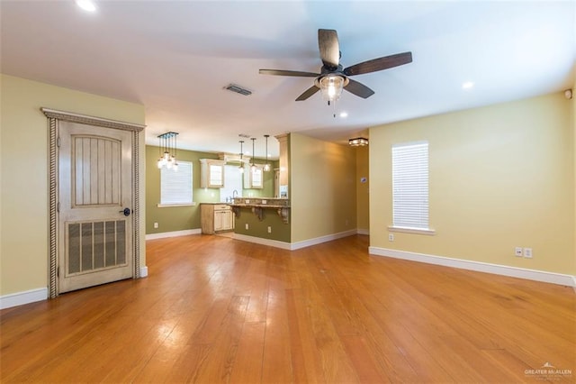 4009 Wescan Ln, Mission, TX 78572 - unfurnished living room featuring ceiling fan, wood-type flooring, and sink