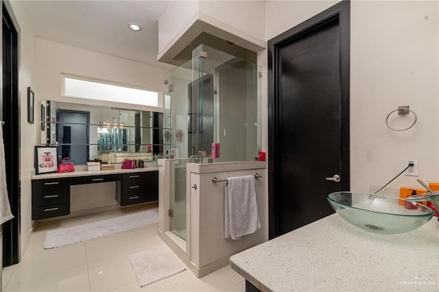 bathroom with vanity, an enclosed shower, and tile patterned flooring