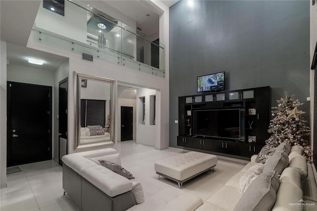 living room featuring light tile patterned floors and a high ceiling