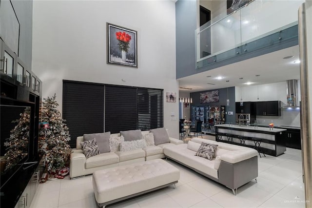 tiled living room with a towering ceiling