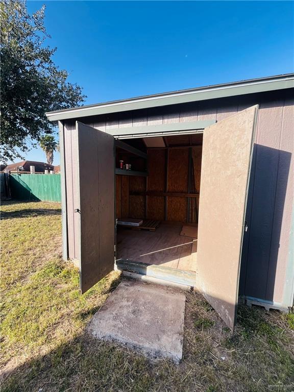 view of outbuilding featuring a lawn