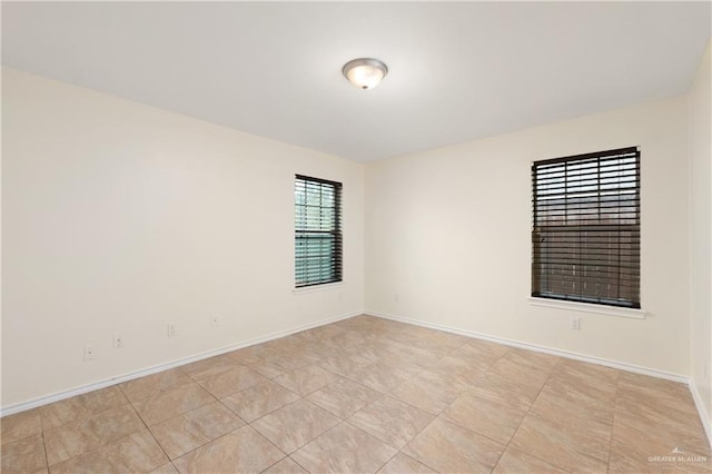 unfurnished room featuring baseboards