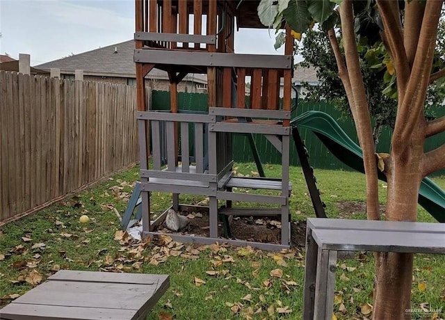 view of jungle gym featuring a fenced backyard and a lawn