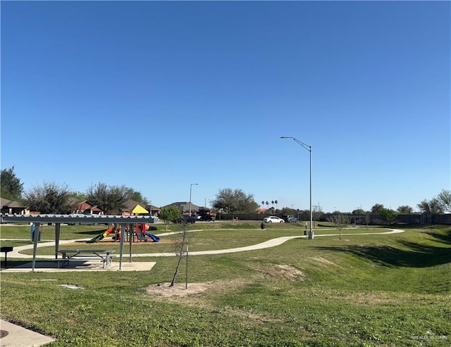 surrounding community featuring playground community and a yard