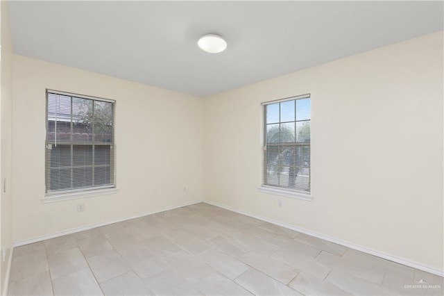 spare room featuring baseboards