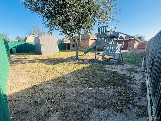 view of yard featuring a storage shed and a playground