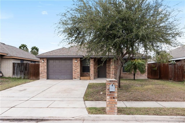 single story home with concrete driveway, brick siding, an attached garage, and fence