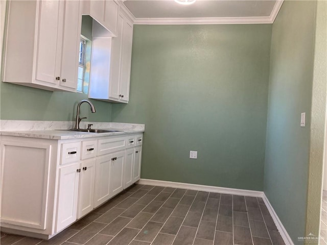 washroom with crown molding and sink