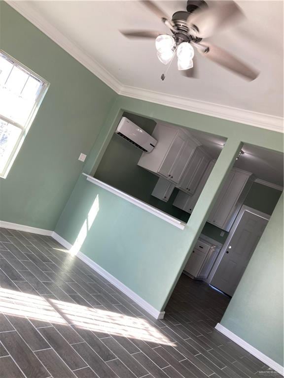 interior space with a wall mounted air conditioner, ornamental molding, and dark wood-type flooring