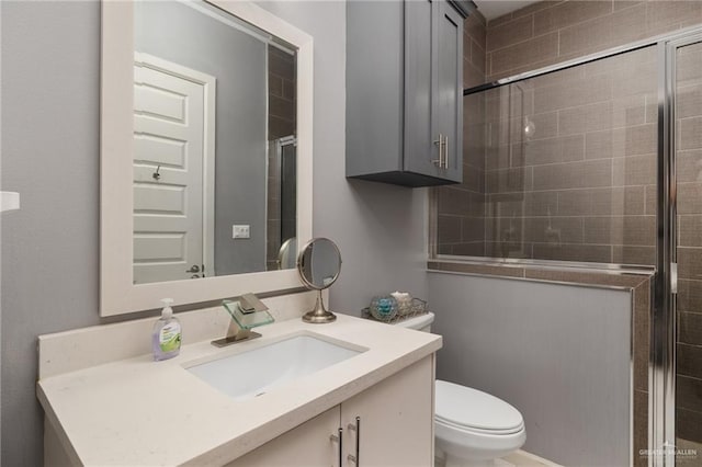 bathroom with vanity, toilet, and walk in shower