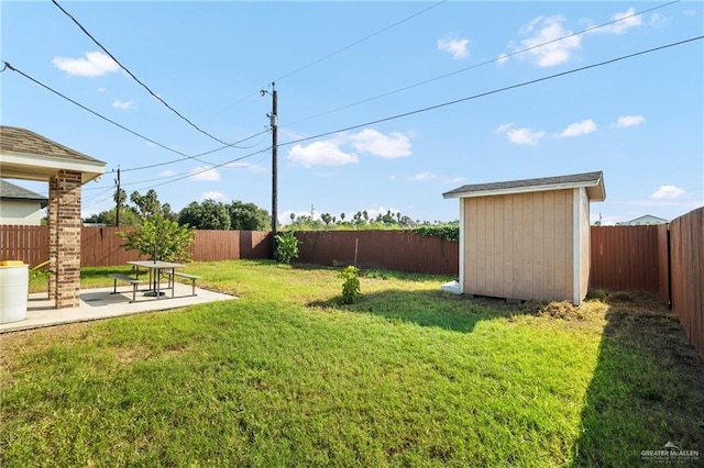 view of yard with a shed and a patio area