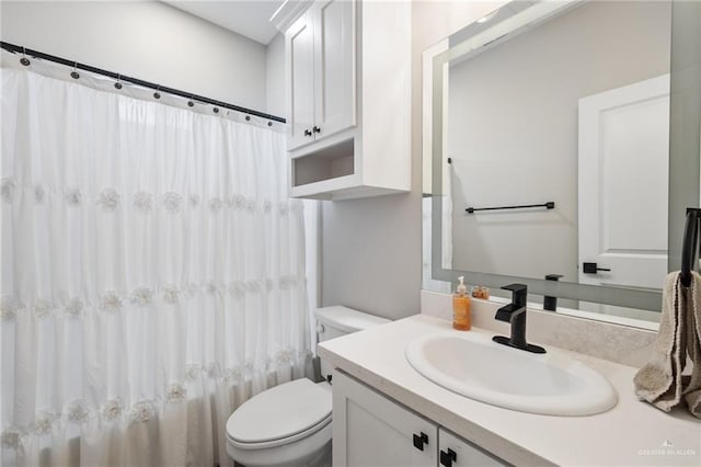 full bathroom with vanity, shower / tub combo, and toilet