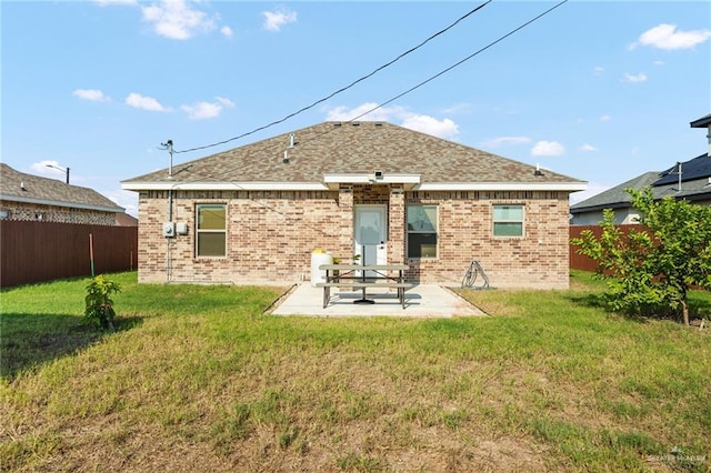 back of house featuring a yard and a patio