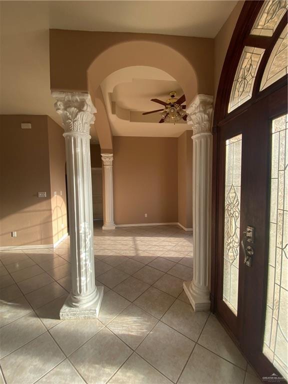 entryway featuring light tile patterned floors, decorative columns, and ceiling fan