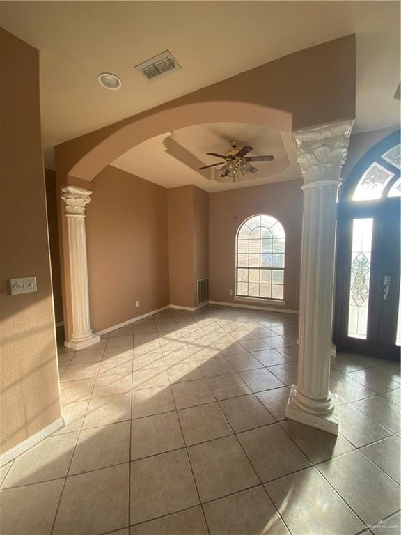 tiled foyer featuring ceiling fan, ornate columns, a wealth of natural light, and french doors