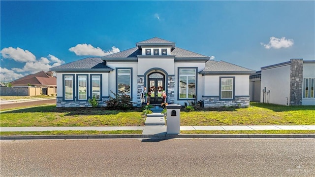 view of front of property with a front lawn and french doors