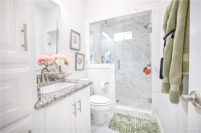 bathroom featuring vanity, an enclosed shower, and toilet