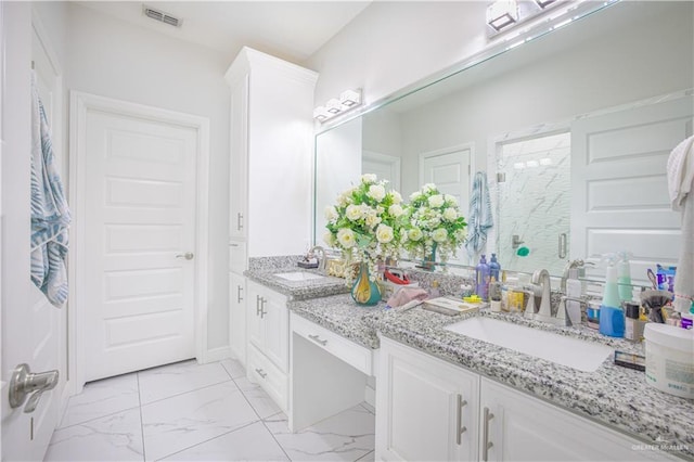 bathroom featuring vanity and a shower with shower door