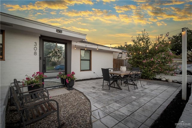 view of patio terrace at dusk