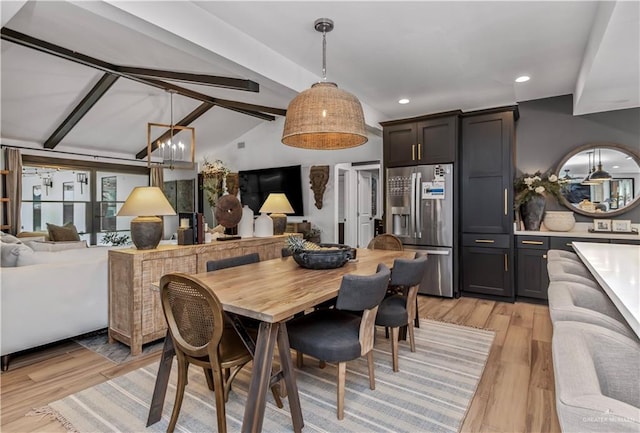 dining room featuring lofted ceiling with beams, light hardwood / wood-style flooring, and a notable chandelier