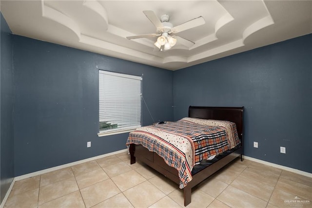 bedroom with ceiling fan, light tile patterned flooring, and a raised ceiling