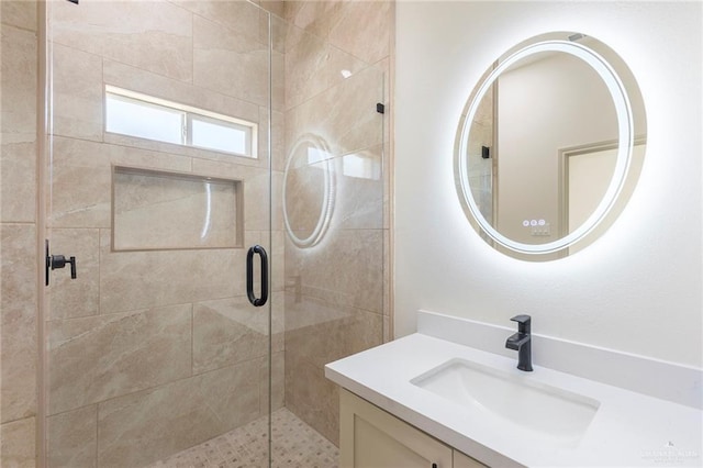 bathroom featuring a shower stall and vanity