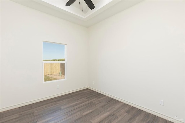 spare room with a ceiling fan, baseboards, and wood finished floors