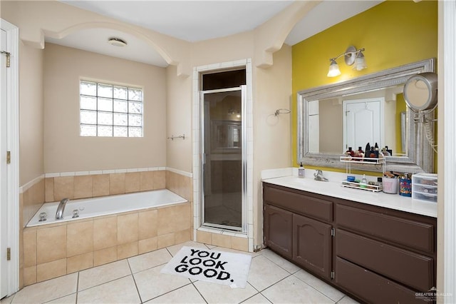 bathroom with tile patterned floors, vanity, and plus walk in shower