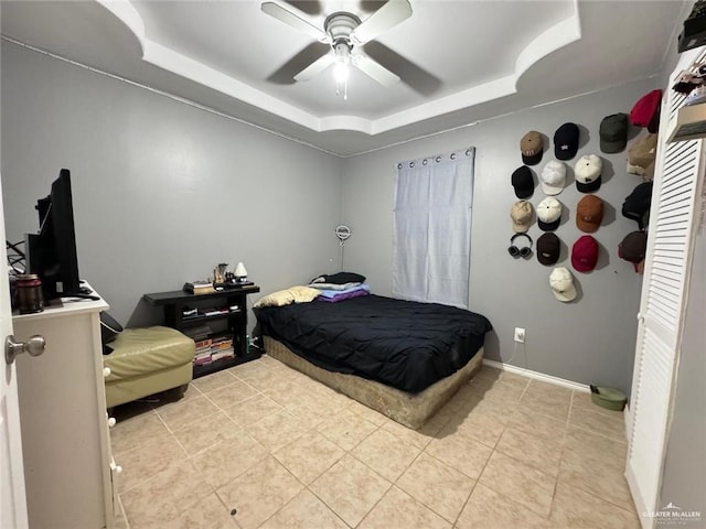 606 Baily Dr, San Juan, TX 78589 - bedroom featuring a raised ceiling, light tile patterned flooring, a ceiling fan, and baseboards