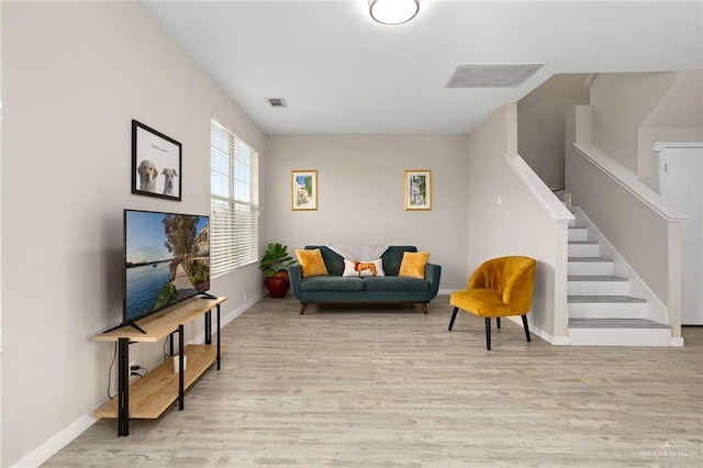 6009 Midcrown Dr, San Antonio, TX 78218 - living room featuring light wood finished floors, baseboards, and stairway