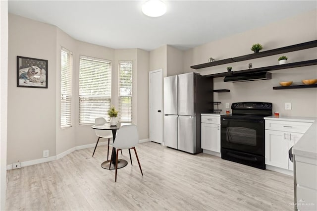 6009 Midcrown Dr, San Antonio, TX 78218 - kitchen with black / electric stove, freestanding refrigerator, open shelves, under cabinet range hood, and light wood-style floors