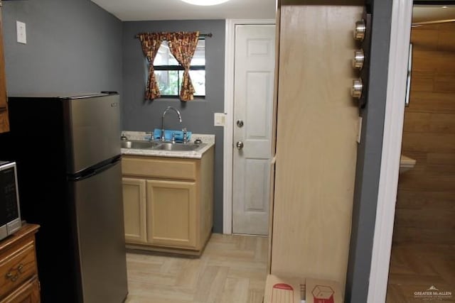 kitchen featuring sink, light parquet flooring, and stainless steel appliances