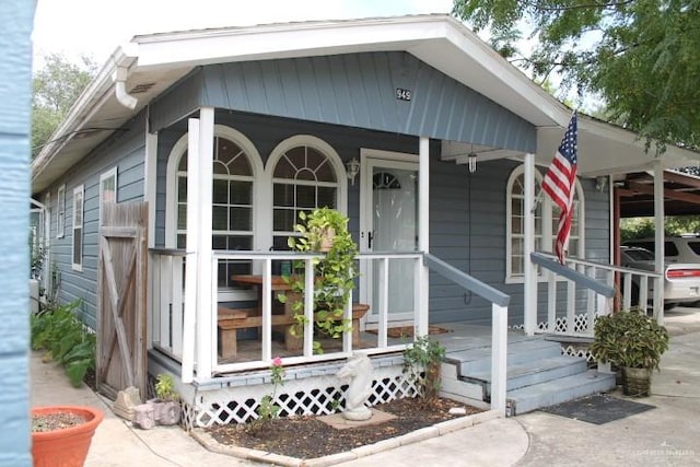 exterior space with a carport and covered porch