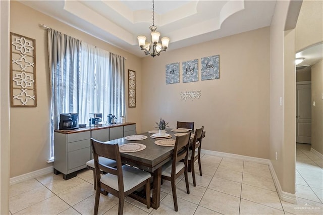 612 Persimmon Ave, Edinburg, TX 78539 - dining area with a chandelier, a raised ceiling, and light tile patterned flooring