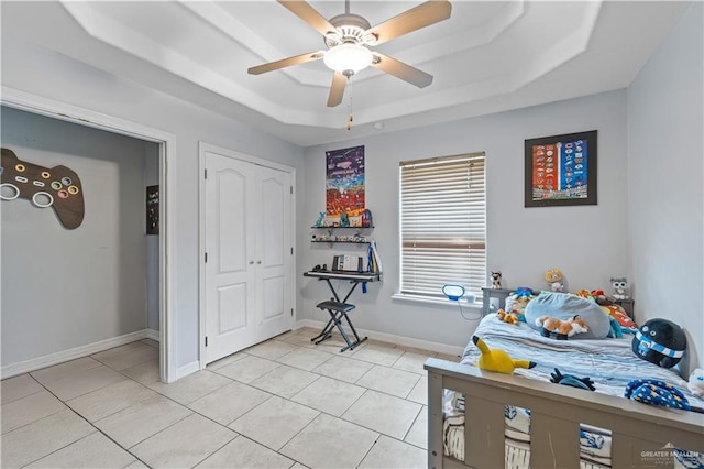 612 Persimmon Ave, Edinburg, TX 78539 - bedroom with a tray ceiling, light tile patterned floors, and ceiling fan