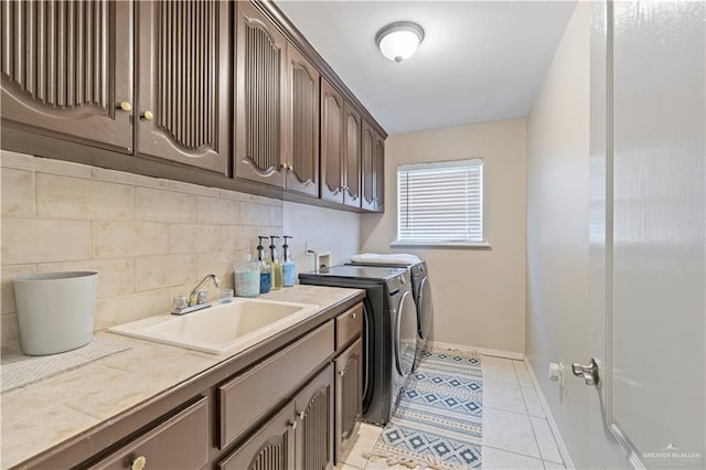 612 Persimmon Ave, Edinburg, TX 78539 - laundry area featuring independent washer and dryer, cabinet space, and light tile patterned floors