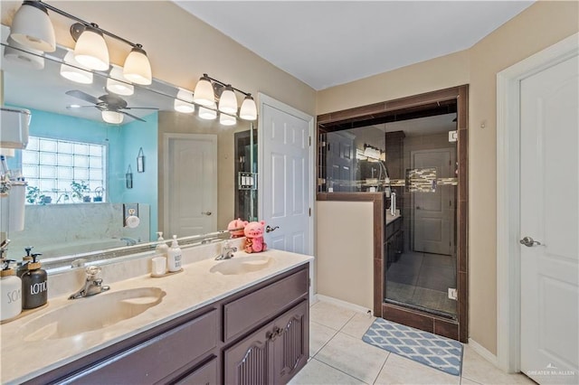 612 Persimmon Ave, Edinburg, TX 78539 - bathroom with a ceiling fan, a garden tub, double vanity, a shower stall, and tile patterned flooring