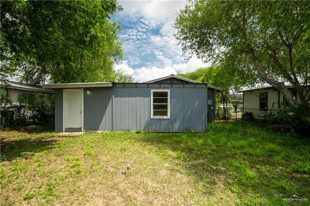 exterior space with an outdoor structure and a yard