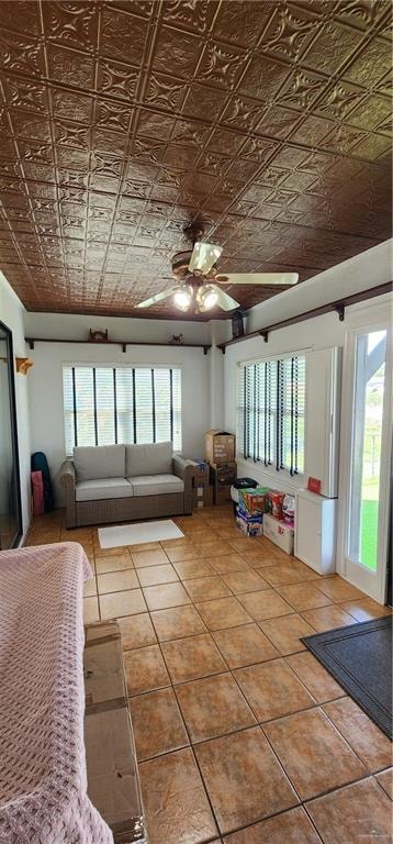 unfurnished living room with tile patterned flooring and ceiling fan