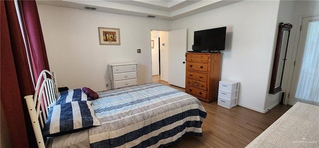 bedroom with dark wood-type flooring